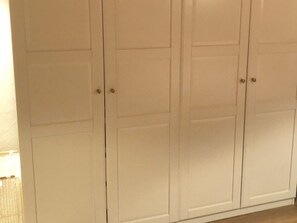 A set of white double doors with a simple design, likely leading to a closet or storage area. - Casa Alpetta, (Flumserberg Tannenboden), by Interhome (Flumserberg Tannenheim)