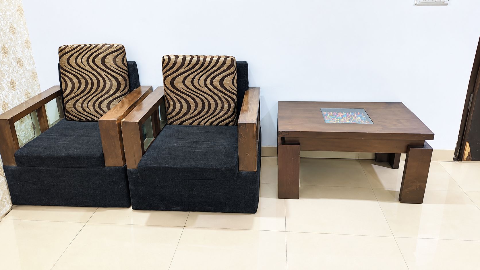 A sofa set with a matching ottoman and a wooden coffee table.