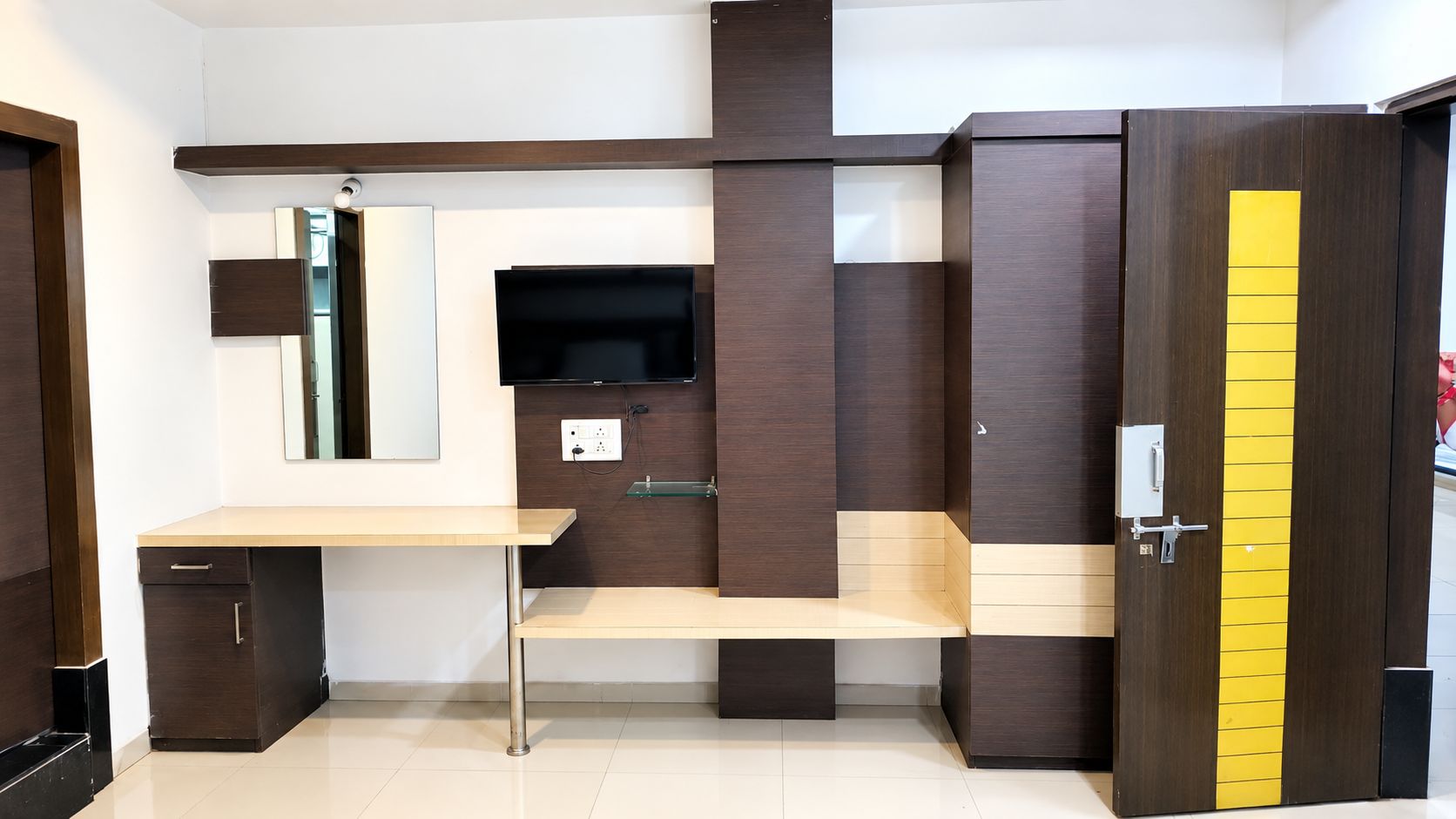 A modern bedroom with a bed, bedside table, and a wardrobe.