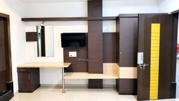 A modern bedroom with a bed, bedside table, and a wardrobe.