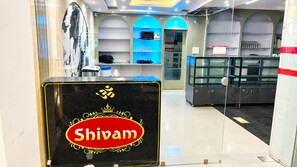 A commercial interior with a prominent sign for 'Shivam' in the foreground.