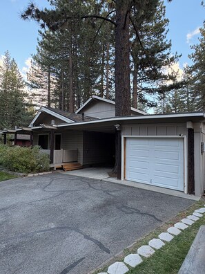 A two-story building with a garage and a covered porch. - Peaceful 4-bedroom house in South Lake Tahoe perfect for families (South Lake Tahoe)