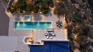 An aerial view of a rooftop pool area with a seating arrangement and a small water feature. - Luxe Private Hilltop Escape Pool & Spa 360-views (Valley Center)