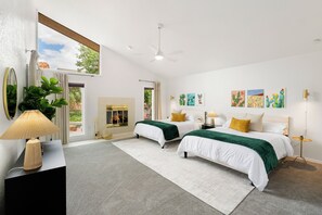 A modern bedroom with two beds, a fireplace, and artwork on the walls. - Luxury Red Rock Retreat:  3 Bed/ 2 Bath With Heated Pool & Spa, Game Room (Sedona)
