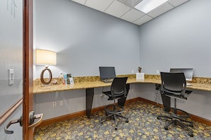 A conference room with a long table, two chairs, a lamp, and a computer on the table. - Family 4br, Private Pool, Resort Amenities (Kissimmee)