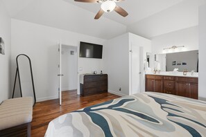 A bedroom with a bed, a dresser, a vanity with a mirror, and a ceiling fan. - Charming Gilbert Home: Primary Suite, Flex 2nd BR/Office, Near Park & Downtown (Gilbert)