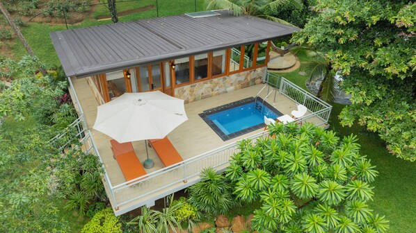 A two-story house with a balcony, a swimming pool, and a patio area with outdoor furniture. - Browns Barn Habaraduwa (Bandaranayake)