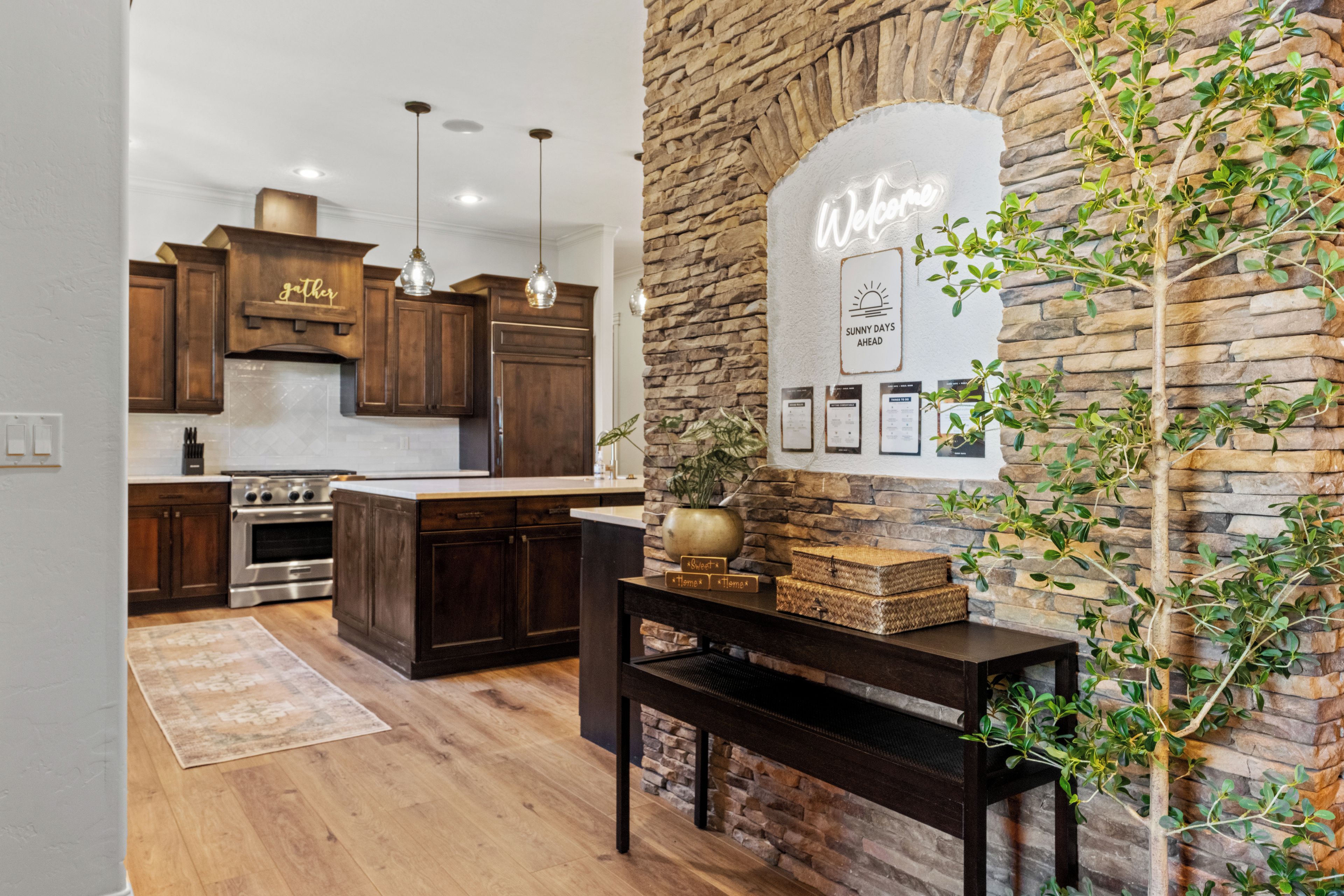 A modern kitchen with dark wood cabinets, a central island, and pendant lighting.
