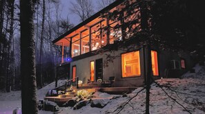 A modern house with large windows, a covered porch, and steps leading up to the entrance. - The View. by Edelweiss ski hill. (Wakefield)