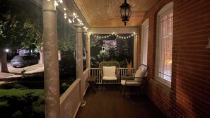 A porch with string lights, two chairs, and a table. - Stunning Victorian home with easy access to the best of Boulder - and Sundance! (Boulder)