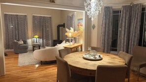 A dining area with a round wooden table, six chairs, and a chandelier. - Stunning Victorian home with easy access to the best of Boulder - and Sundance! (Boulder)