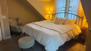 A bedroom with a bed, a chair, a lamp, and a window. - Stunning Victorian home with easy access to the best of Boulder - and Sundance! (Boulder)