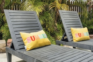 Two lounge chairs with a cushion that reads 'SUMMER' in colorful letters. - Cozy 2-Bedroom Island Retreat for 4 in Old Town Key West by the Tropical Pool (Key West)