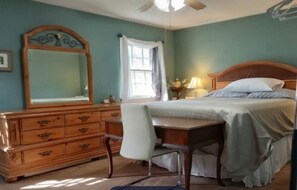 A bedroom with a bed, a dresser, a desk, and a mirror. - 3 Miles to Furniture Market • 8 Beds • Fast Wi‑Fi • Lake Views (High Point)