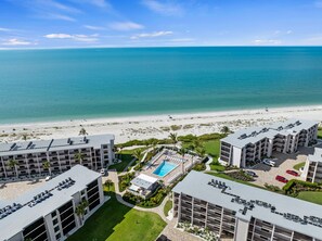 A beachfront hotel with multiple buildings, a pool, and a beach view. - Sundial F203 Sanibel Beach Condo Steps to Beach (Sanibel)