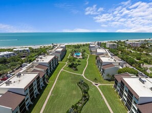 A resort with multiple buildings, a central pool, and a beach view. - Direct Gulf Beachfront Water Views East End (Sanibel)