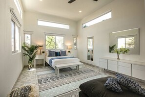 A spacious bedroom with a large bed, bedside tables, a mirror, and a window. - Boutique Bucerías Hacienda | Spacious Private Terrace (Bucerías)