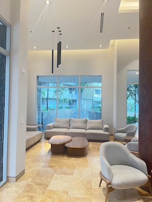 A spacious living area with a large sofa, two armchairs, and a coffee table. - Cozy 1-bedroom Apartment - Condo Sea + Mountain Views (Santa Marta)
