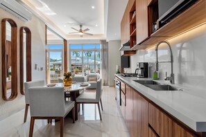 A modern kitchen with a large island, built-in appliances, and a view of the outdoors. - Penthouse 1BR | Rooftop Pool, Hot Tub & Romantic Zone (Puerto Vallarta)