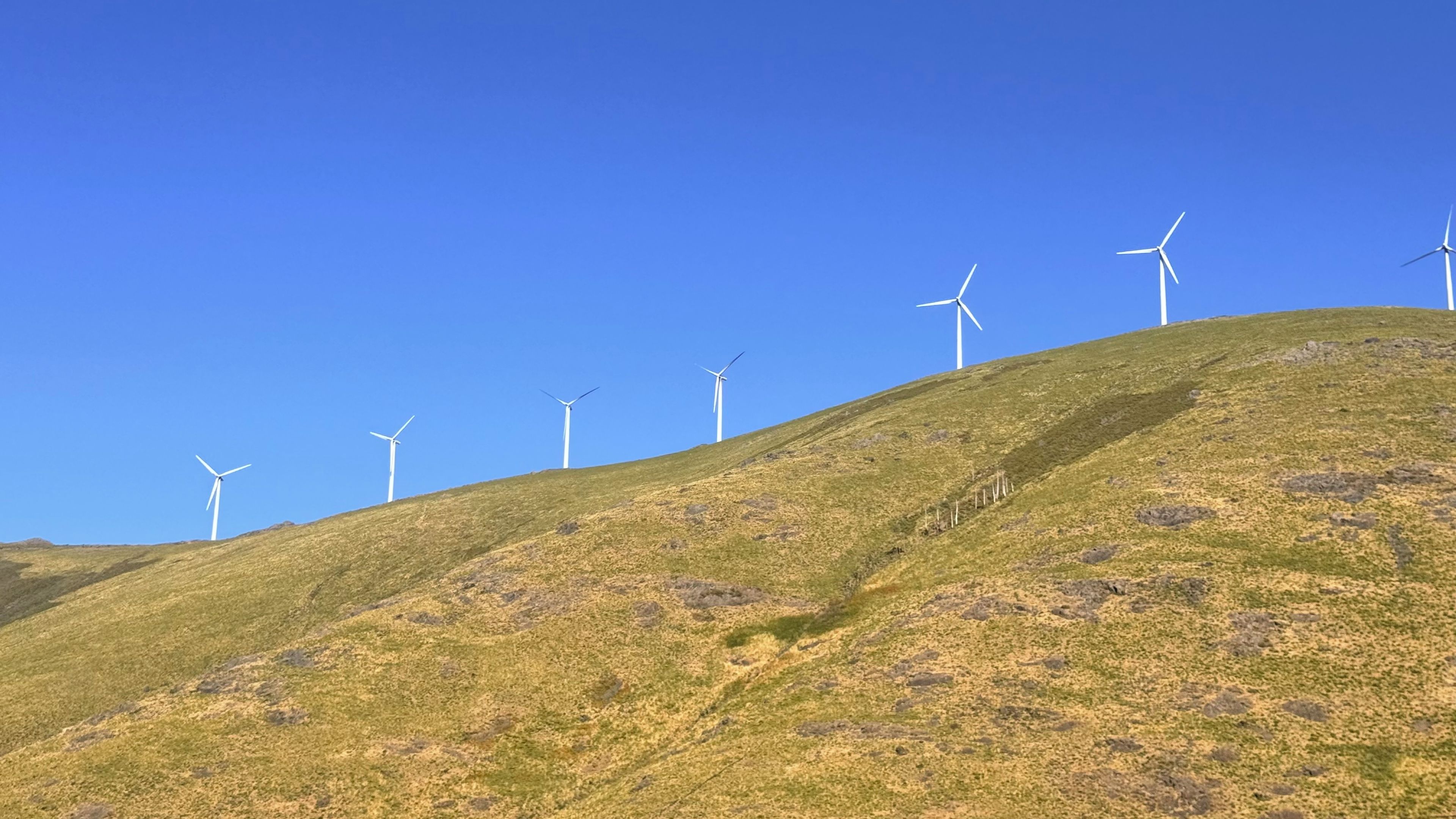 A hill with wind turbines.