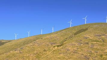 A hill with wind turbines.