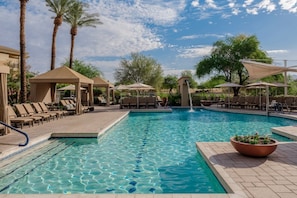 A swimming pool with lounge chairs and umbrellas, surrounded by palm trees and a clear sky. - Westin Kierland Villas · 2BR Sleeps 8 · Golf Views, Pools & Resort Amenities (Scottsdale)