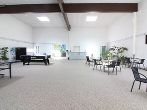 A spacious room with a pool table, several chairs, and potted plants. - "Alena" - 50m from the sea by Interhome (Brovst)