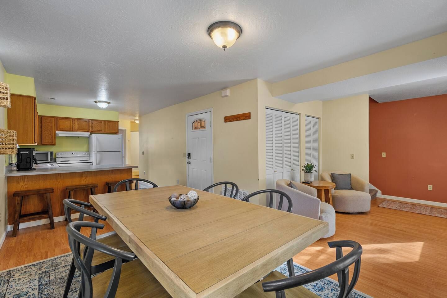 A compact living space with a dining area, kitchenette, and a seating area.