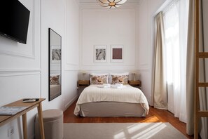 A hotel room with a bed, bedside tables, a flat-screen TV, and artwork on the walls. - Casa Dona Irene Sunny Terrace | Room 1 | Early or Late Check-in (Faro)
