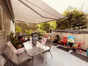 An outdoor patio with a table and chairs, surrounded by potted plants and a covered area. - Puffing Billy Guesthouse: 
Escape the suburbs and enjoy the Dandenong Ranges! (Cockatoo)