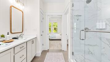 Spa-like bathroom with walk-in marble shower and bright modern vanity