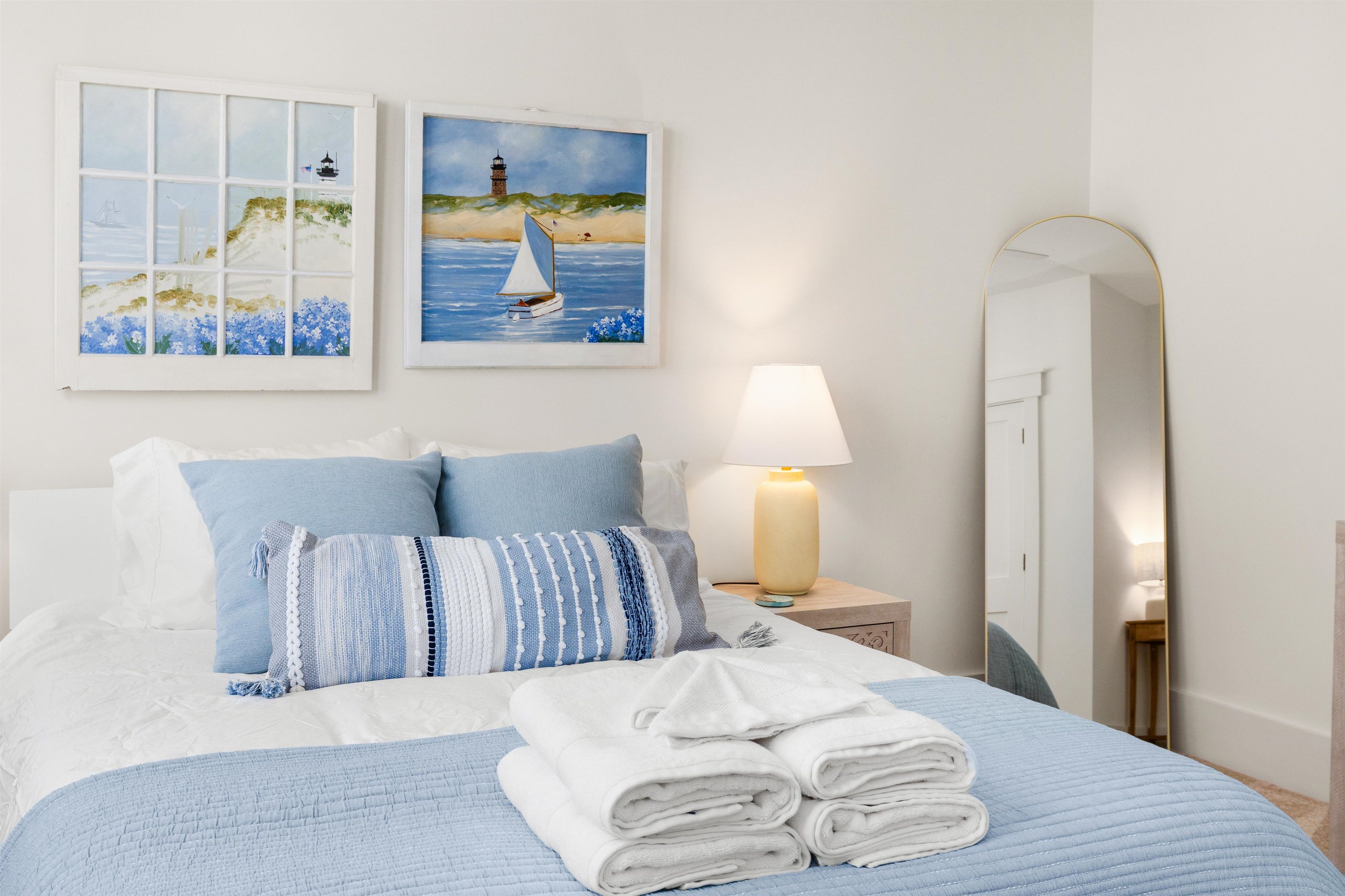 Bright coastal bedroom with soft blue accents and fresh, inviting styling