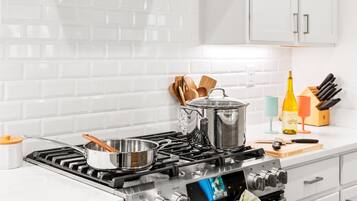 Bright modern kitchen with gas range and sleek white finishes