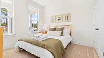 Bright, cozy bedroom with natural light and serene, welcoming decor