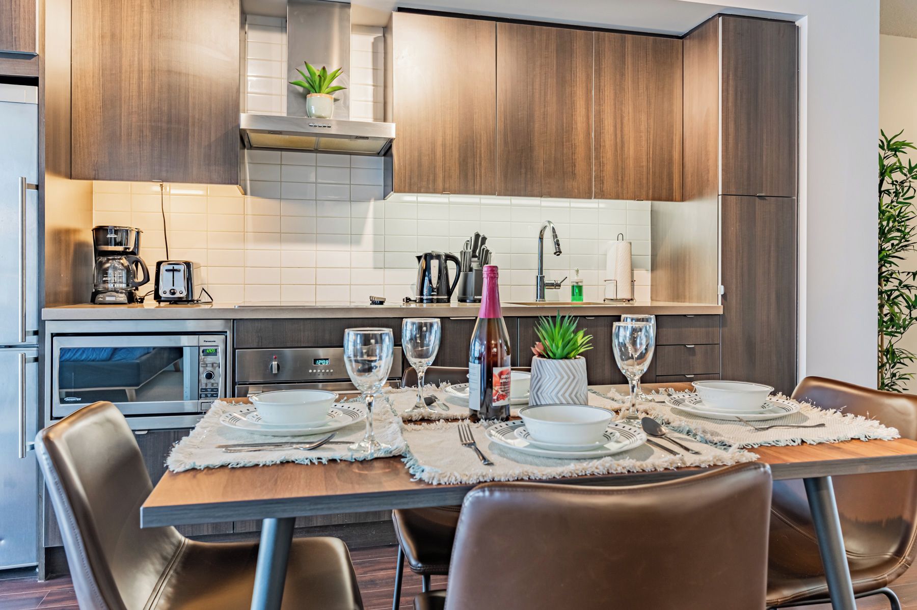 A modern kitchen with a built-in oven, microwave, and coffee maker.