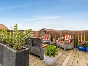 An outdoor patio with wicker furniture and potted plants. - "Aarthi" - 300m from the sea by Interhome (Harboøre)