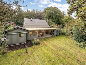 A two-story house with a covered patio area and a small shed. - "Terese" - 200m to the fjord by Interhome (Farsø)