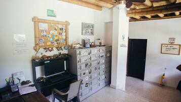 A room with a computer desk, a filing cabinet, and a reception area.