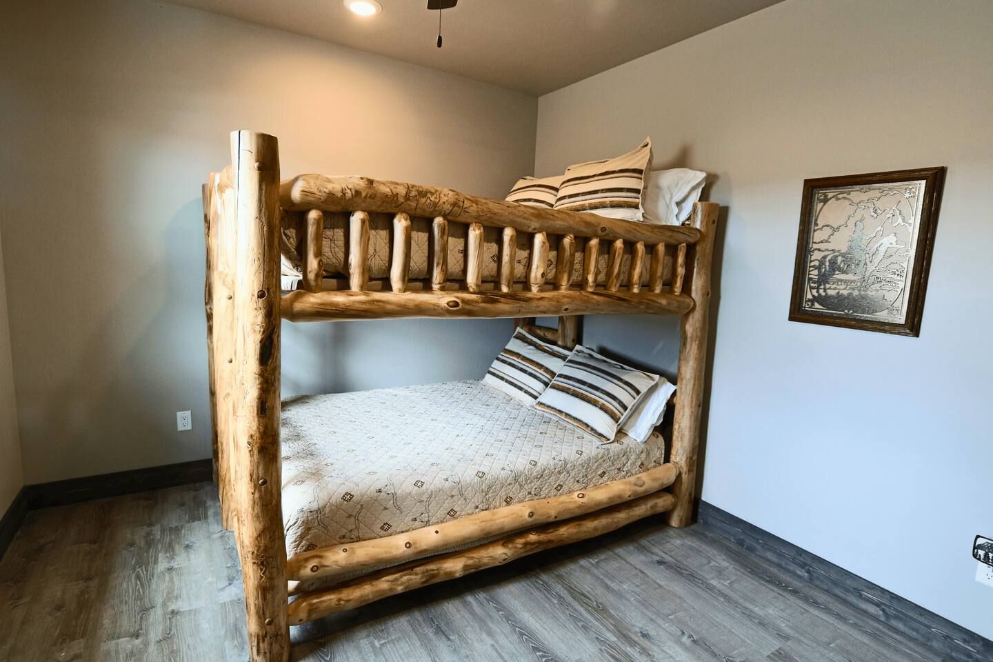 A bunk bed with a wooden frame and patterned bedding.