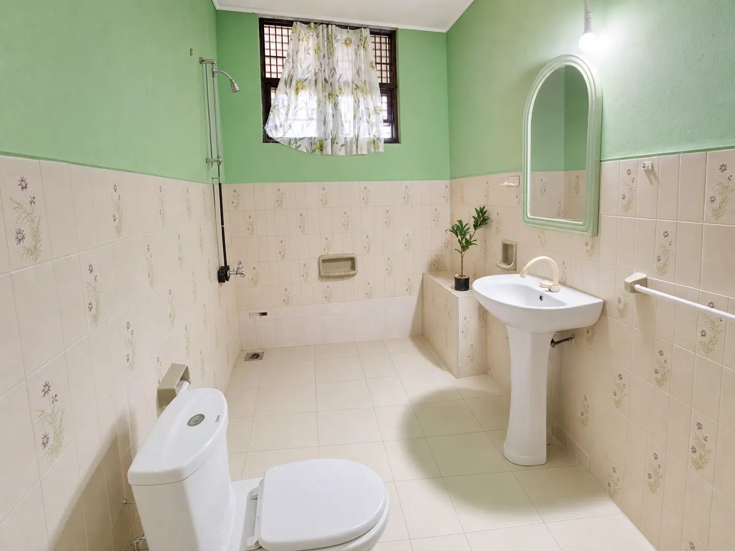 A bathroom with a toilet, sink, and shower.