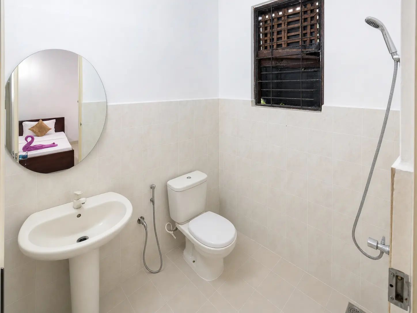 A bathroom with a sink, toilet, and shower.