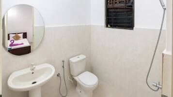 A bathroom with a sink, toilet, and shower.