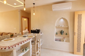 A dining area with a long table, chairs, and a buffet setup. - Authentic Apartment in Tamraght – A Peaceful Stay Near the Beach (Tamraght)