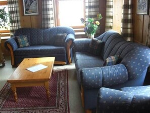 A living room with a sofa, a coffee table, and a rug. - Haus alte Post, (Samnaun-Compatsch) by Interhome (Samnaun)