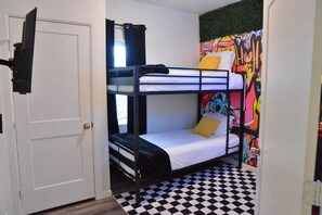 A room with bunk beds, a checkered floor, and a door. - Cozy Austin Getaway - Game Room - Minutes to UT (Austin)