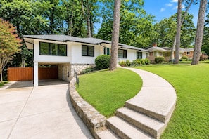 A modern two-story house with a stone foundation, a covered garage, and a well-maintained lawn. - Cozy 1-bedroom apartment in charming Avondale Estates BRAND NEW (Avondale Estates)