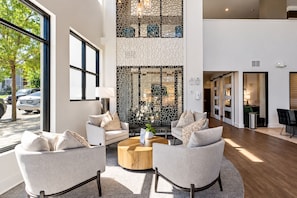 A modern interior with two sofas, a coffee table, and a decorative wall with a geometric pattern. - 5 Minutes to Downtown + Pool + Fitness Gym + Free Parking (Nashville)