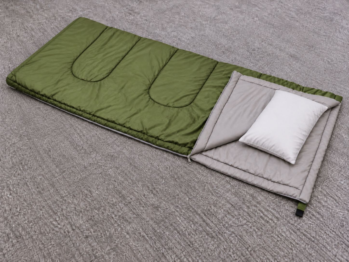 Colchón verde y blanco con un almohadón sobre una alfombra con textura.