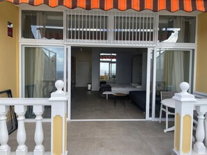 A hotel room with a balcony, a bed, a small table, and a view of the sea. - Studio with a View of the Harbor (Puerto de la Cruz)
