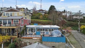 A residential area with multiple houses, including a prominent blue house with a large glass dome structure. - Entire Queen Anne House - 3BR Space Needle View (Seattle)